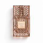 A rectangular perfume bottle with a metallic rose gold finish and a geometric patterned cap, featuring a central label that reads 'KHAMRAH MIRA' and 'Latifa'.
