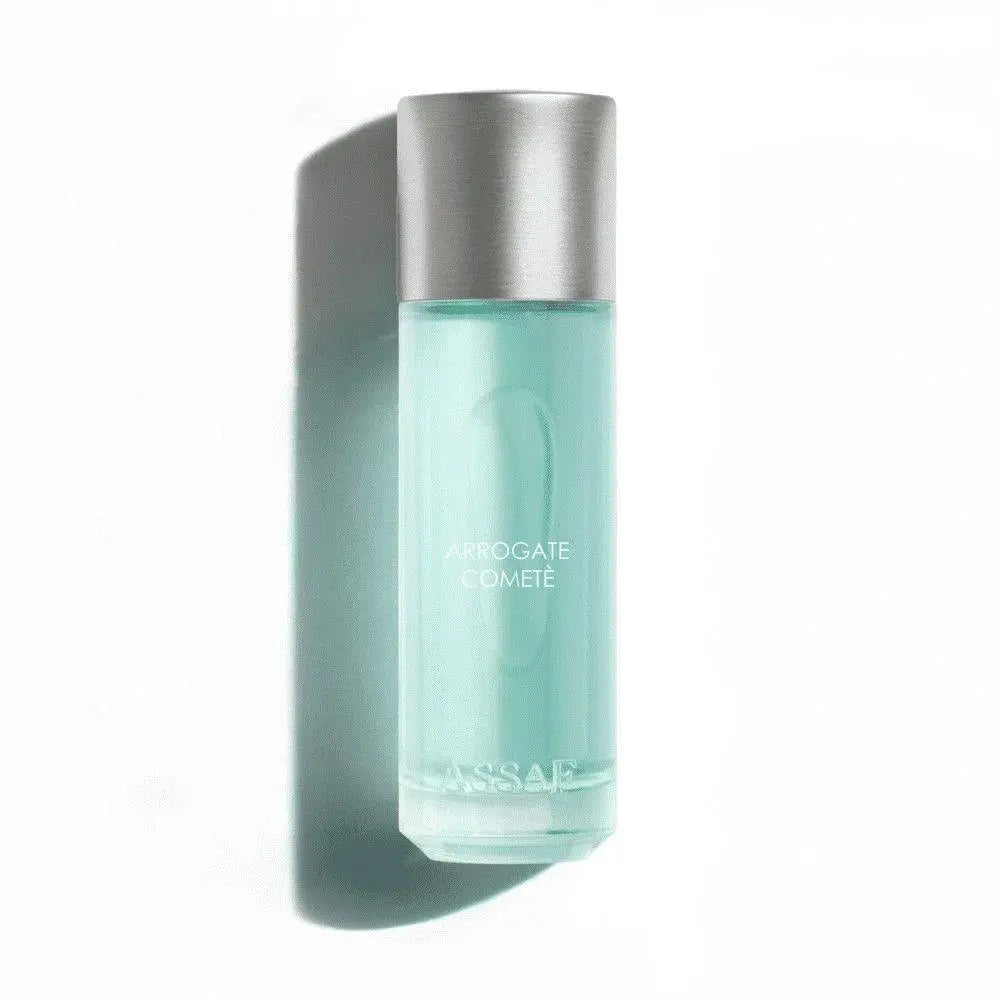 Perfume Arrogate Comete with silver cap and light blue liquid on a white background