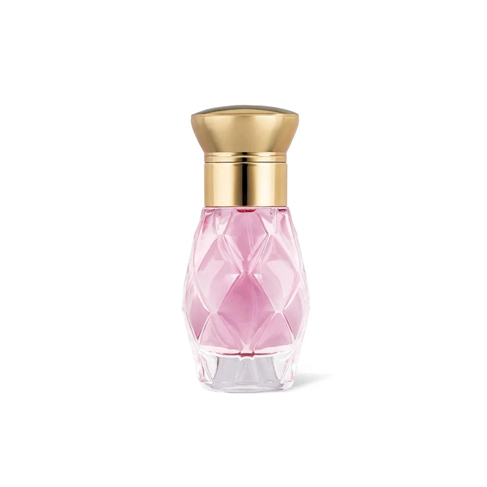 Secret Bloom perfume in a faceted pink bottle with gold cap on white background