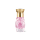 Secret Bloom perfume in a faceted pink bottle with gold cap on white background